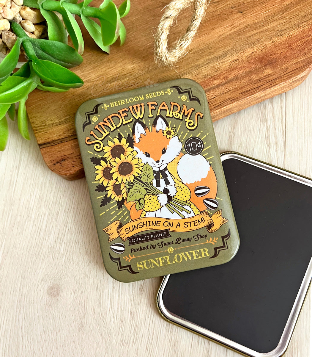 Sundew Farms faux sunflower seed packet fridge magnet with a fox design on a wooden surface.