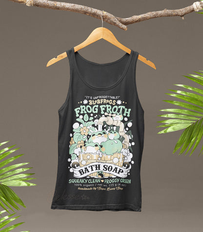 Blobfrogs Frog Froth Bath Soap Tank Top. Dark gray tank top with frog-themed graphic design on a hanger against a brown background with green leaves.