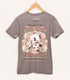A warm gray shirt on a wood hanger with a print of a vintage-style logo for Blossom Opossum Toilet Water, the art featuring a baby opossum in bloomers hanging upside down and surrounded by blossoms. The flavor text reads "Classy, Not Trashy" and "Drop-dead gorgeous by nature."