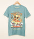 A dusty blue shirt on a wood hanger with a print of a vintage-style logo for Chasing Rays Sun Lotion, the art featuring an energetic, floppy-eared dog wearing a bandana and sunglasses. The flavor text reads, "Sun&