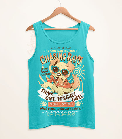 A teal tank top on a wood hanger with a print of a vintage-style logo for Chasing Rays Sun Lotion, the art featuring an energetic, floppy-eared dog wearing a bandana and sunglasses. The flavor text reads, "Sun&