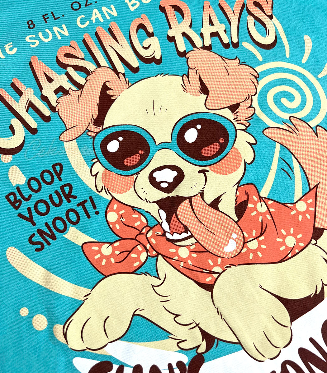 A close-up photo of the print of a teal tank top with a vintage-style logo featuring a floppy-eared dog wearing sunglasses and a bandana, with their tongue hanging out.
