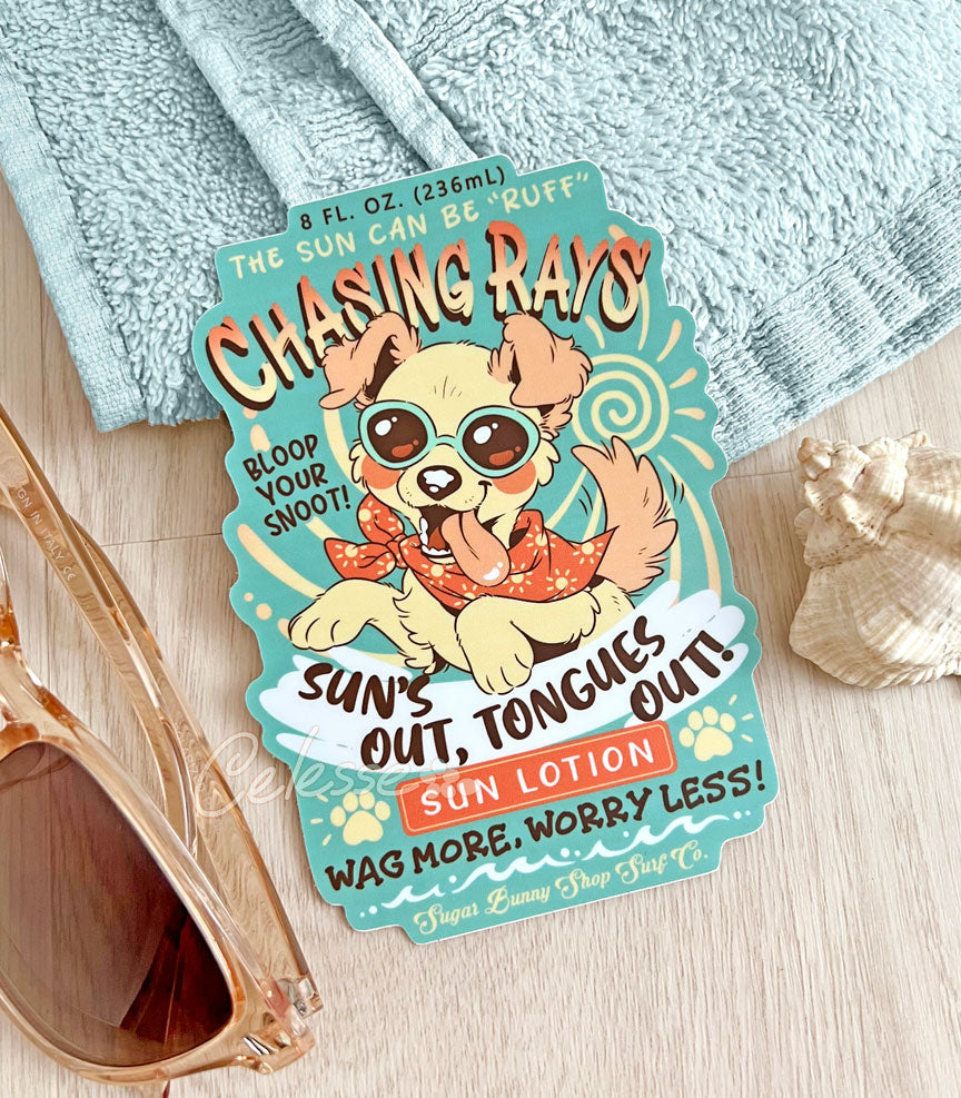 An extra large vinyl sticker of a vintage-style logo for Chasing Rays Sun Lotion, the art featuring an energetic, floppy-eared dog wearing a bandana and sunglasses. The flavor text reads, "Sun&