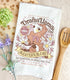 A white kitchen tea towel with a vintage-style logo for Drama Llama Bleater&