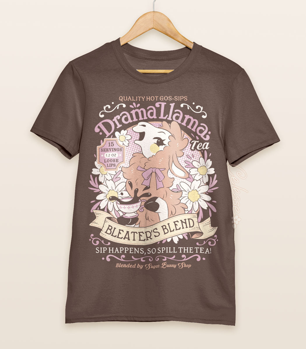 A brown shirt on a wood hanger with a print for a faux vintage-style logo for Drama Llama Tea, the art featuring a gossipy llama spilling the tea.