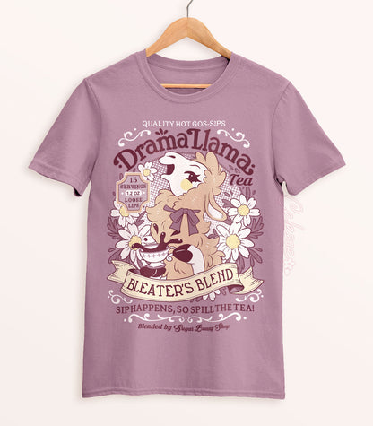 A muted lilac shirt on a wood hanger with a print for a faux vintage-style logo for Drama Llama Tea, the art featuring a gossipy llama spilling the tea.
