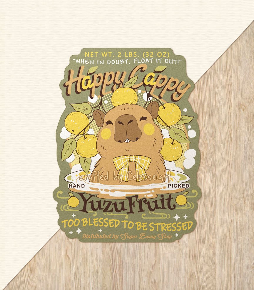 A vinyl sticker of a vintage-style logo for Happy Cappy Yuzu Fruit, the illustration featuring a blissful-looking capybara sitting in a hot spring pool with yuzu spread around it. The secondary text reads "When in doubt, float it out!" and "Too blessed to be stressed."