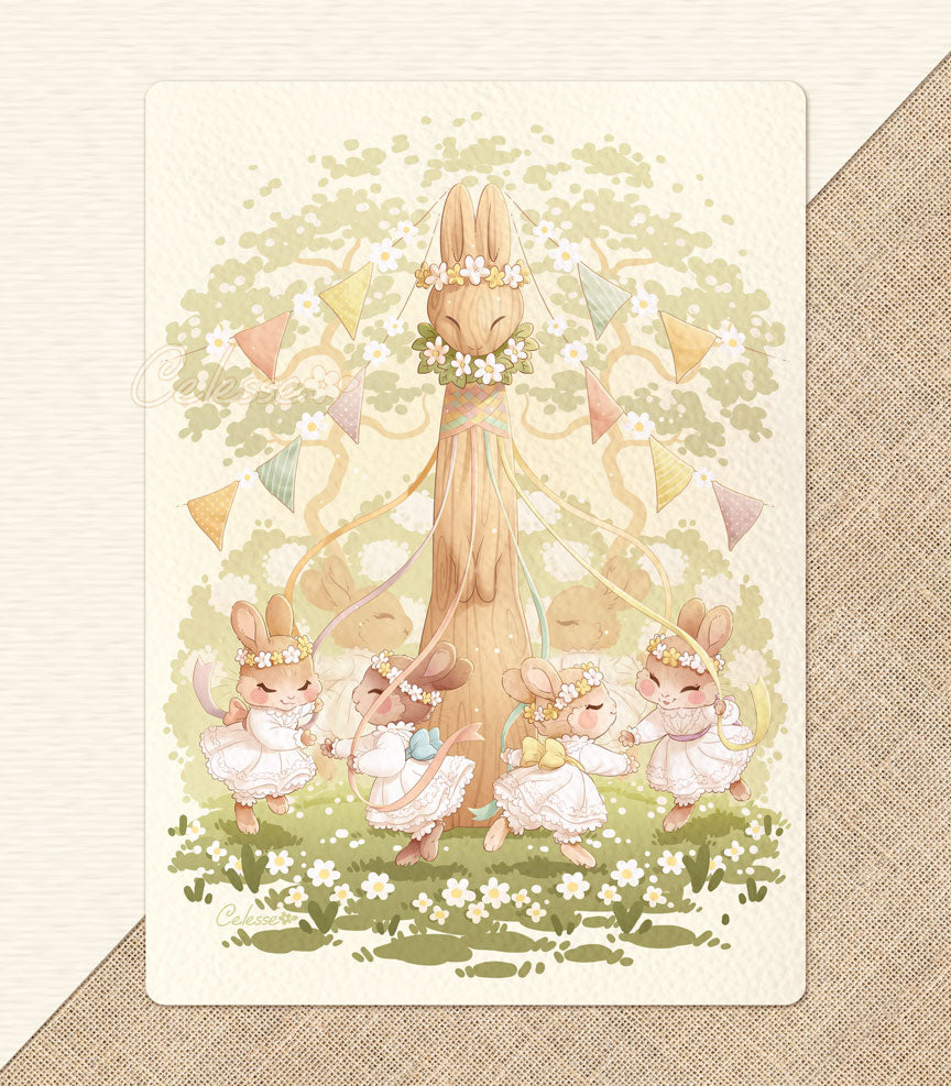 A photo of a textured art print featuring a soft springtime illustration set in a sunny glade, a group of young bunny girls in frilly white dresses and flower crowns prancing around a tall wooden maypole carved in the shape of a rabbit. Each girl holds a ribbon and reaches for the paw of the next girl as they dance, braiding the ribbons around the neck of the maypole. Colorful flags are strung from the top of the pole and flowering trees, bushes and grass decorate the background. 