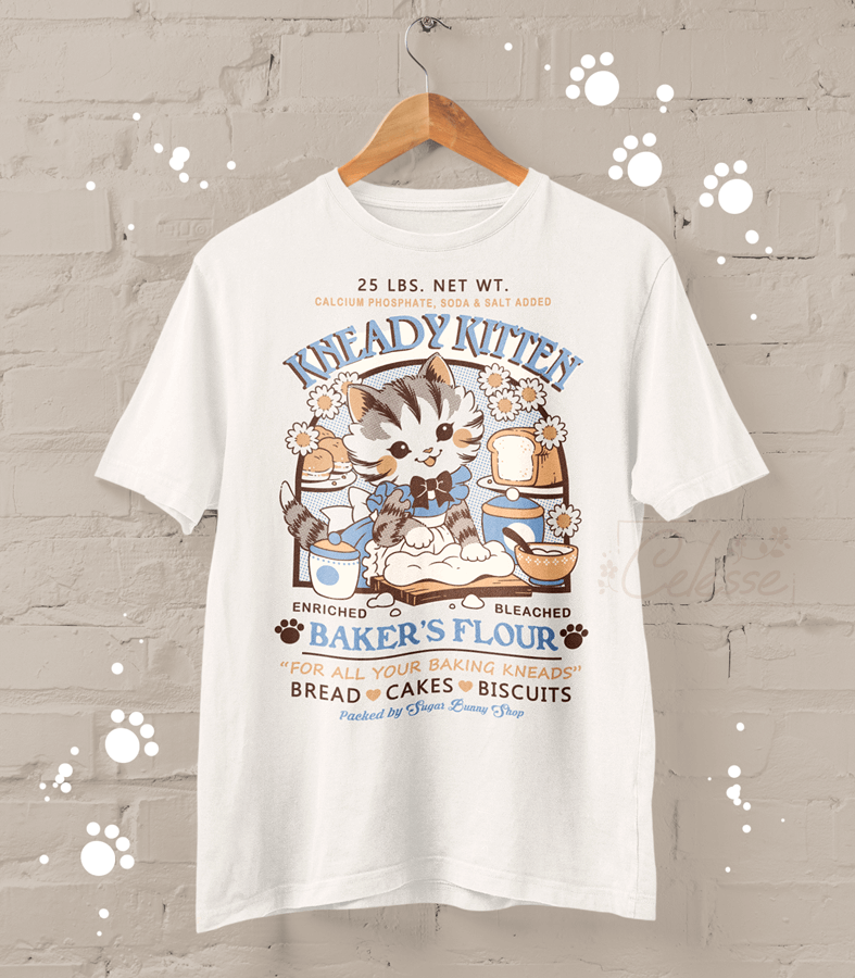 A photo of a shirt featuring an old-timey graphic design for Kneady Kitten Baker&